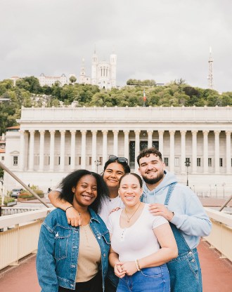 Group of students from the INSEEC business school posing in front of a historic building in Lyon
