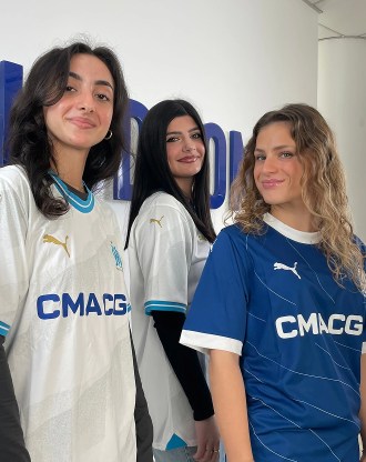 Photo of students wearing Olympique de Marseille shirts at the Velodrome