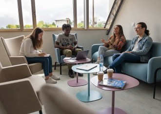 Group of INSEEC commerce students chatting and laughing in a rest alcove on the Rennes campus